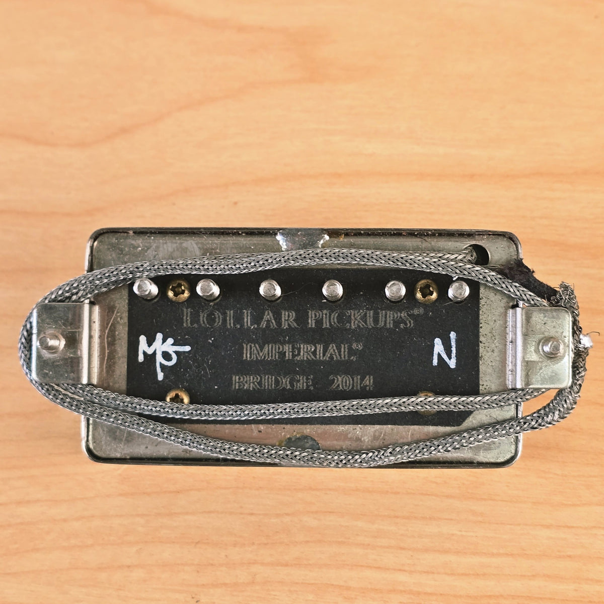 Underside of the 2014 Lollar Imperial bridge pickup showing wire leads and engraving.