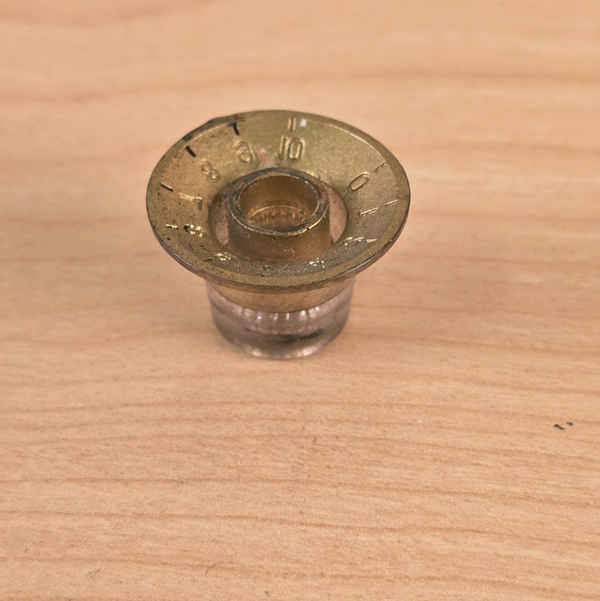 Bottom angled view of gold top hat guitar control knob interior