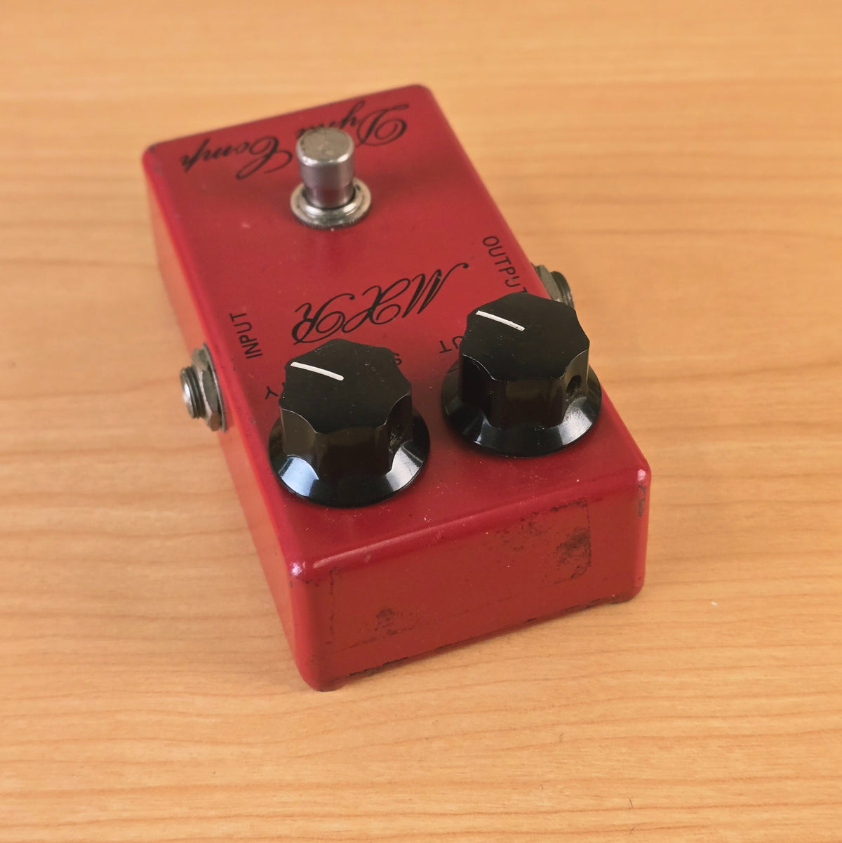 Top angled perspective showing the control knobs and top edge of the MXR Dyna Comp pedal.