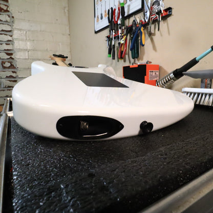 Rear body view resting on tech bench showing black backplate.