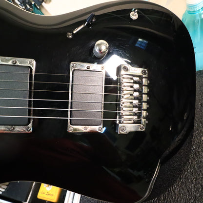 Closeup view of active pickups, volume control, mini switch, and Gibraltar bridge