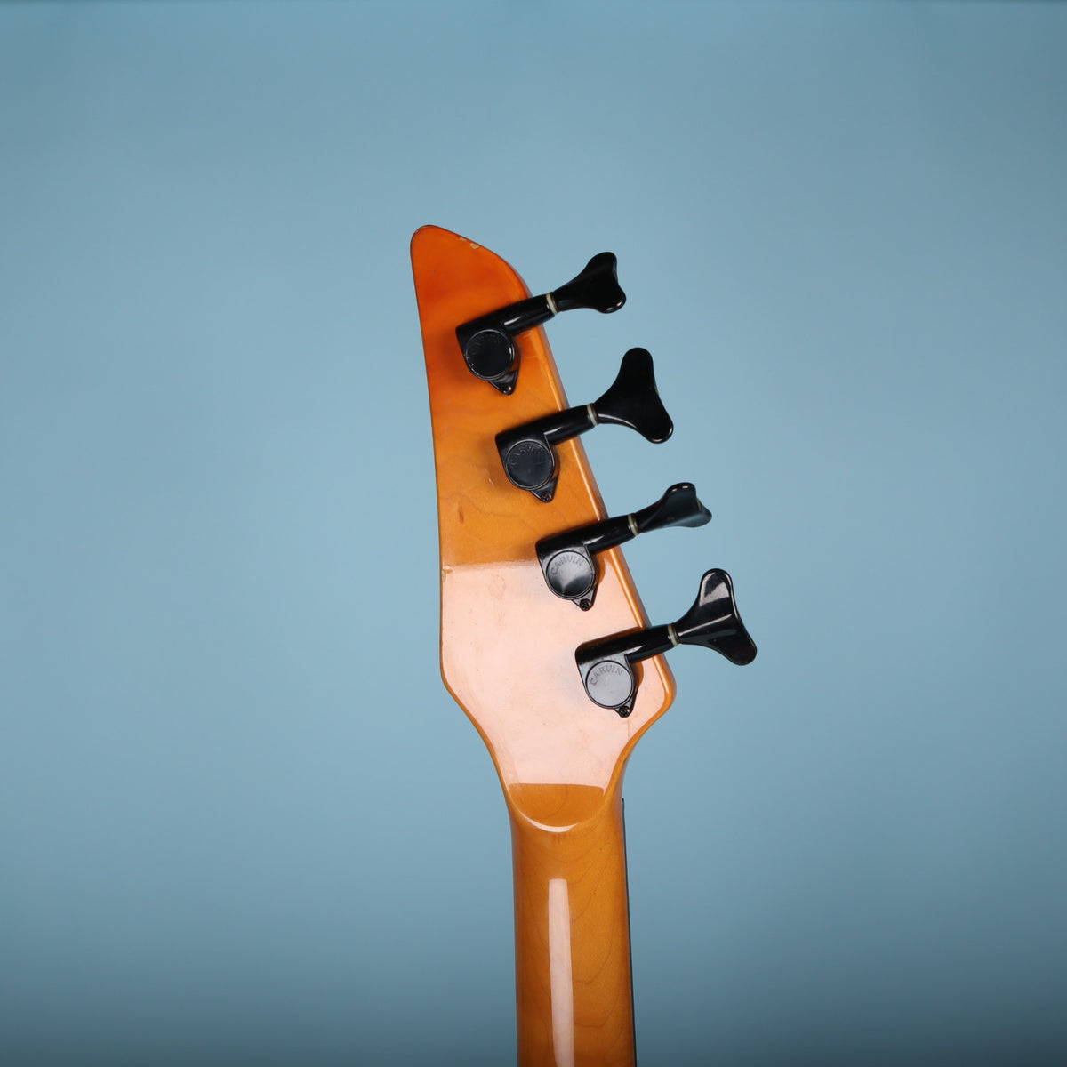 Rear of the headstock showing four black Carvin tuners in line.