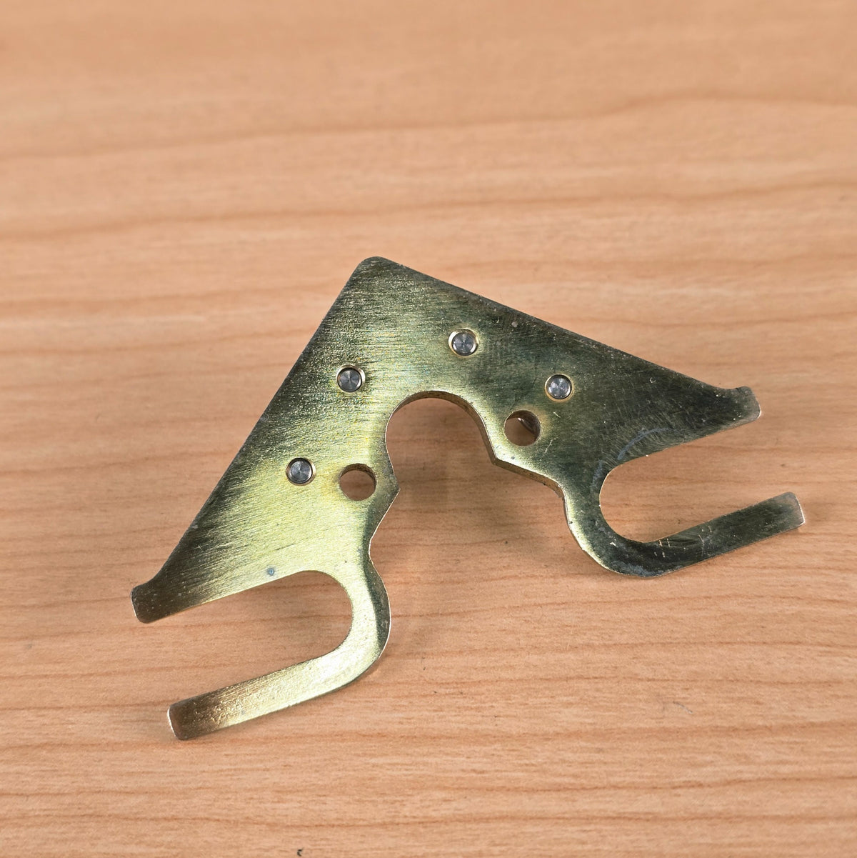 Underside perspective of baseplate showing metal finish and mounting slots
