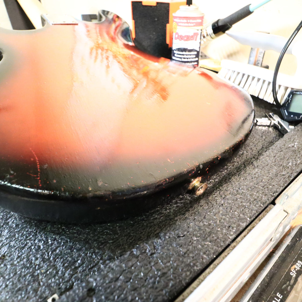 Close-up of the rear strap button and lower body edge wear.