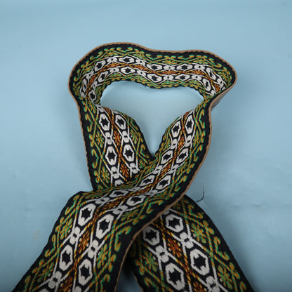 Loop of the strap displaying the vibrant woven design against the light blue backdrop.
