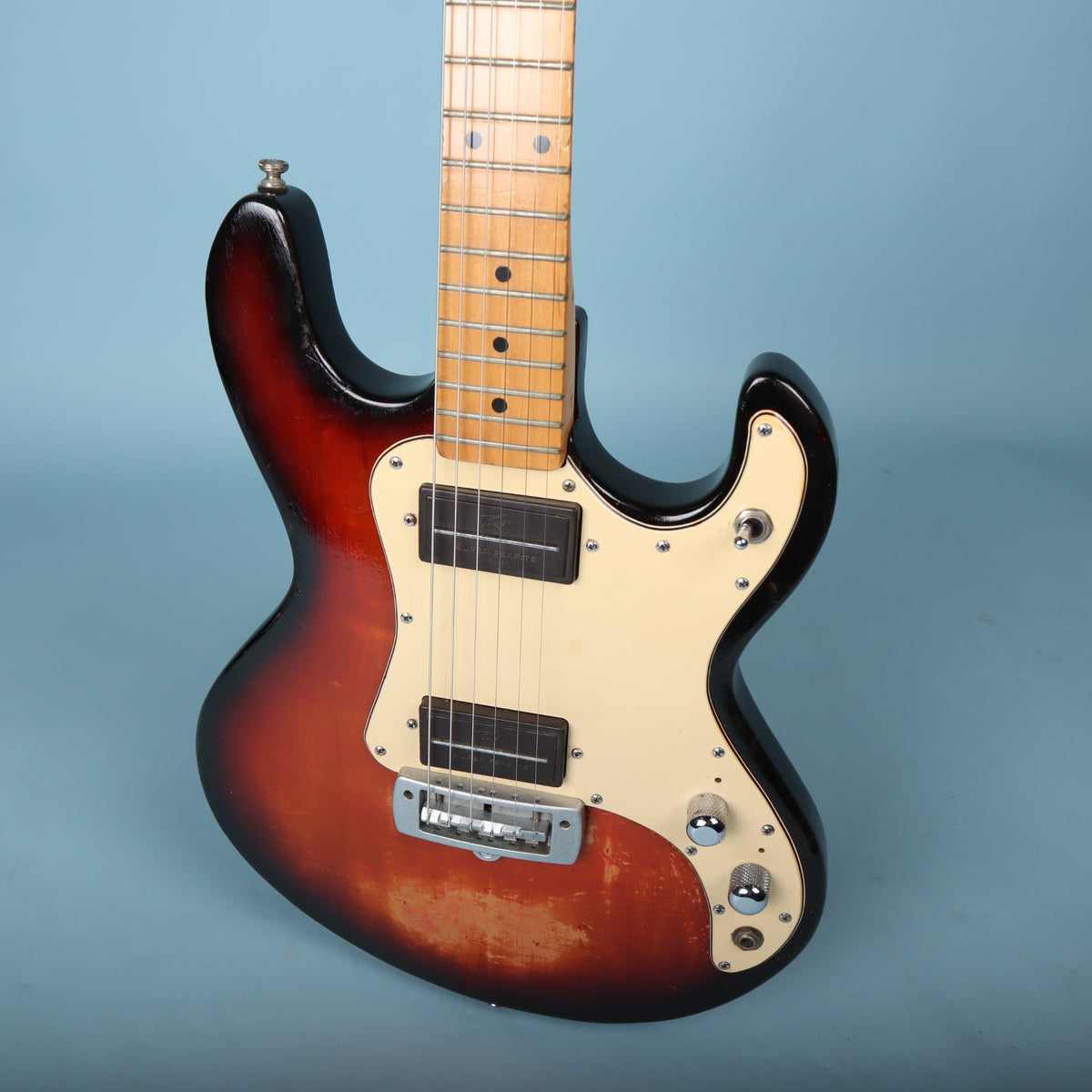 Angled perspective of the Peavey T-15 body, pickguard, and pickups.