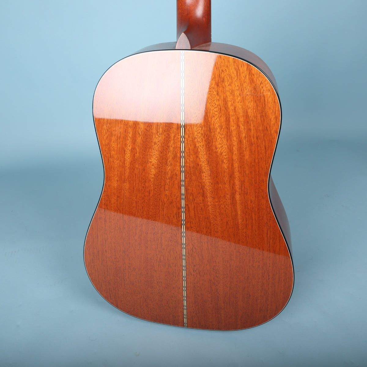 Angled back view showing mahogany grain and binding