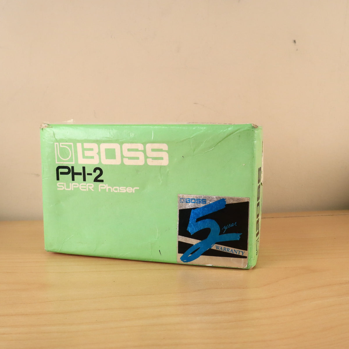 Angle view of the green BOSS PH-2 Super Phaser top panel with warranty decal.