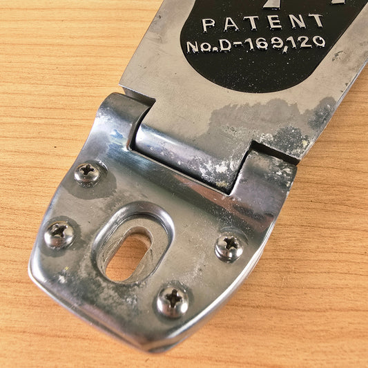 Close-up of the Bigsby hinge plate showing mounting holes with four installed screws.