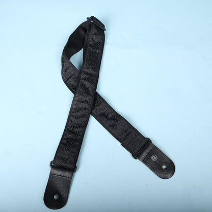 Overhead view of the complete Planet Waves black woven guitar strap.