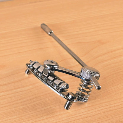 Low perspective view of the Duesenberg Les Trem II vibrato on a wooden surface.