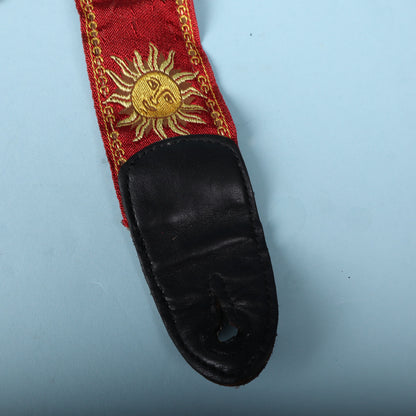Close-up of the black leather end tab and red sun jacquard weave