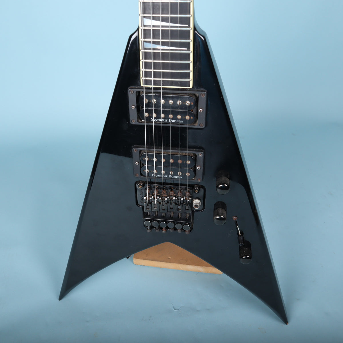 Close-up front view of the pickups, Floyd Rose bridge, and control knobs