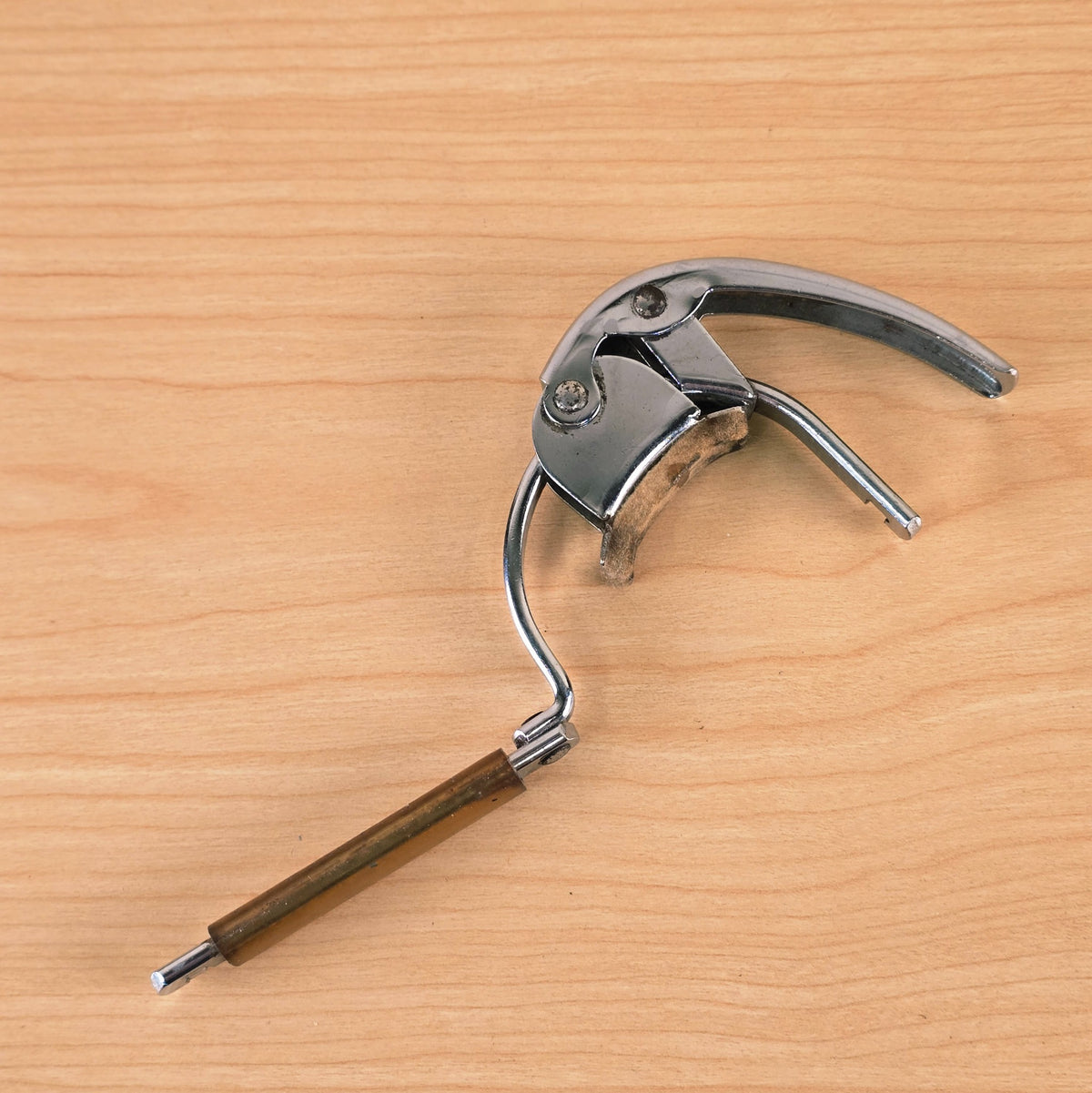 Overhead view of the open Hamilton KB19A capo displaying the full latch arm extension.