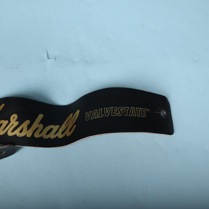 Close-up view of the Valvestate text printed in gold on the guitar strap end