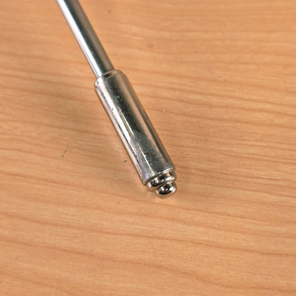 Detail view of the chrome-plated metal tip of the tremolo arm showing light surface patina.