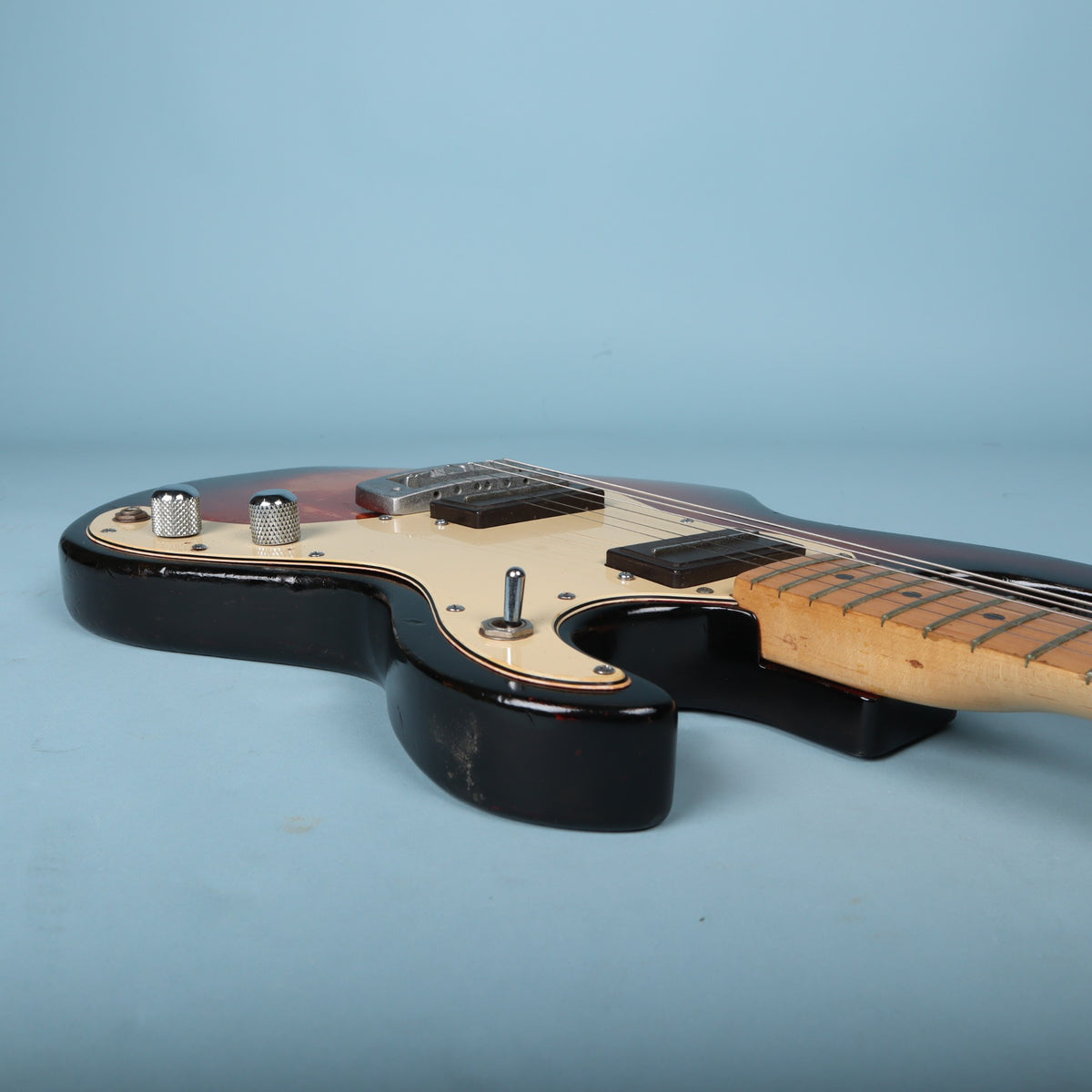 Side angle along the bass side of the body and neck joint.
