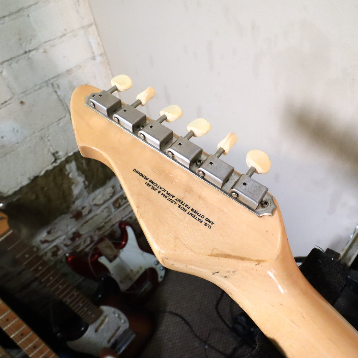 Rear of the headstock showing tuners on the work bench.
