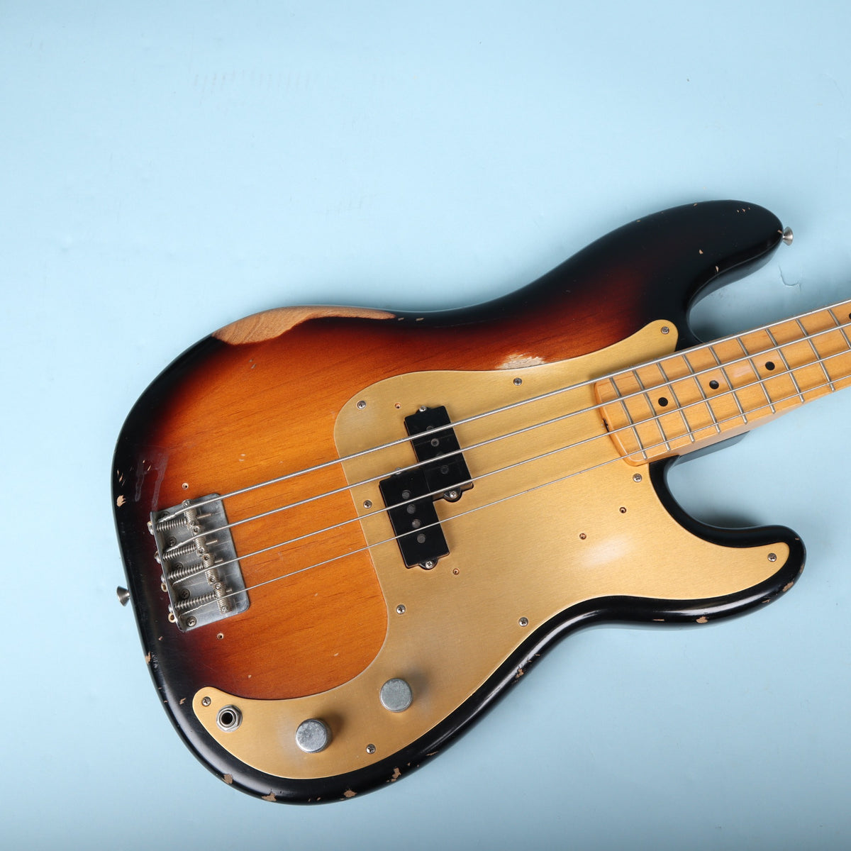Angled top-down view of the body, split single-coil pickup, and gold pickguard.