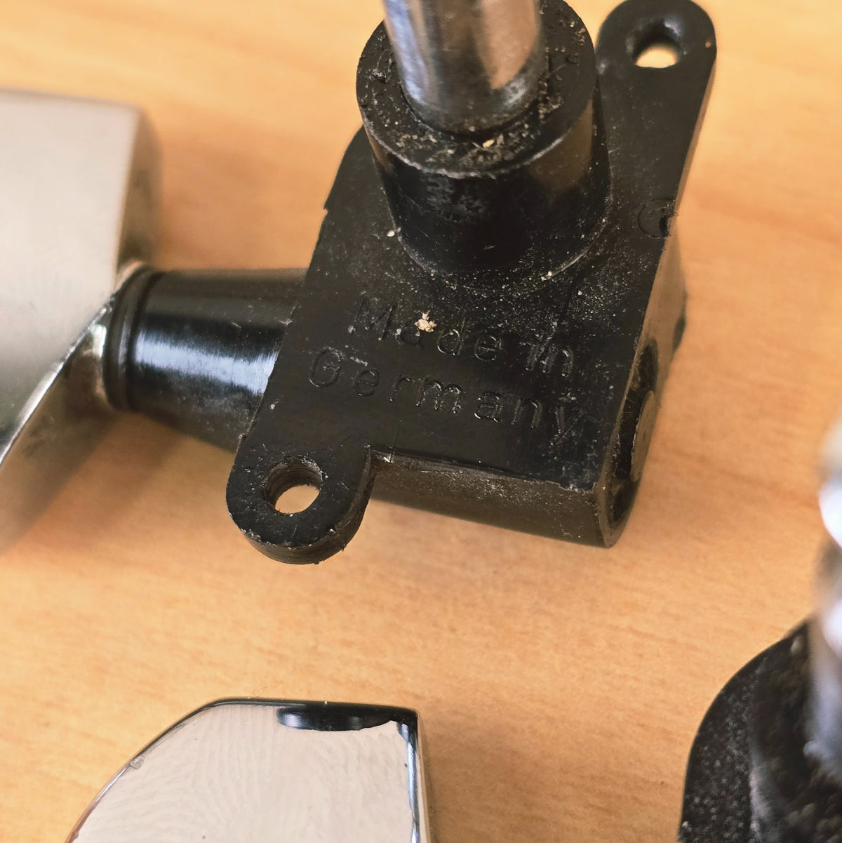 Side view of six Schaller tuning machine posts and buttons with bushings