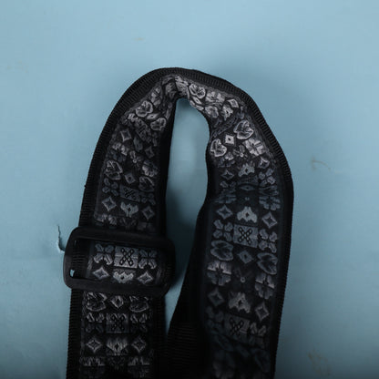Upper folded loop of the strap showing the woven pattern and plastic hardware.