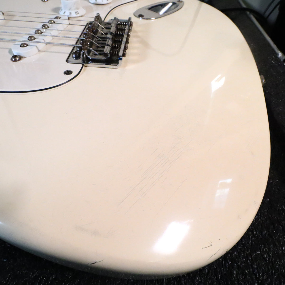Close-up of body finish showing light surface scratches on lower bout
