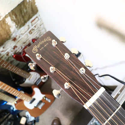 Martin 0-18 headstock angled view on a tech workbench.