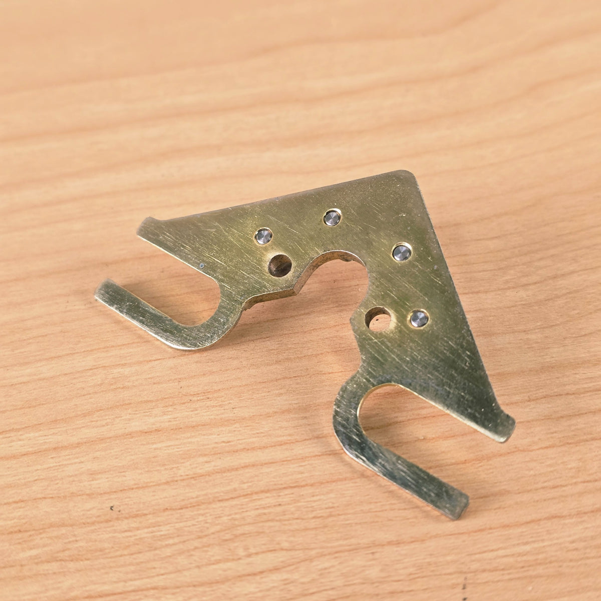 Rear view of String Butler V3 baseplate showing flush-set roller rivets