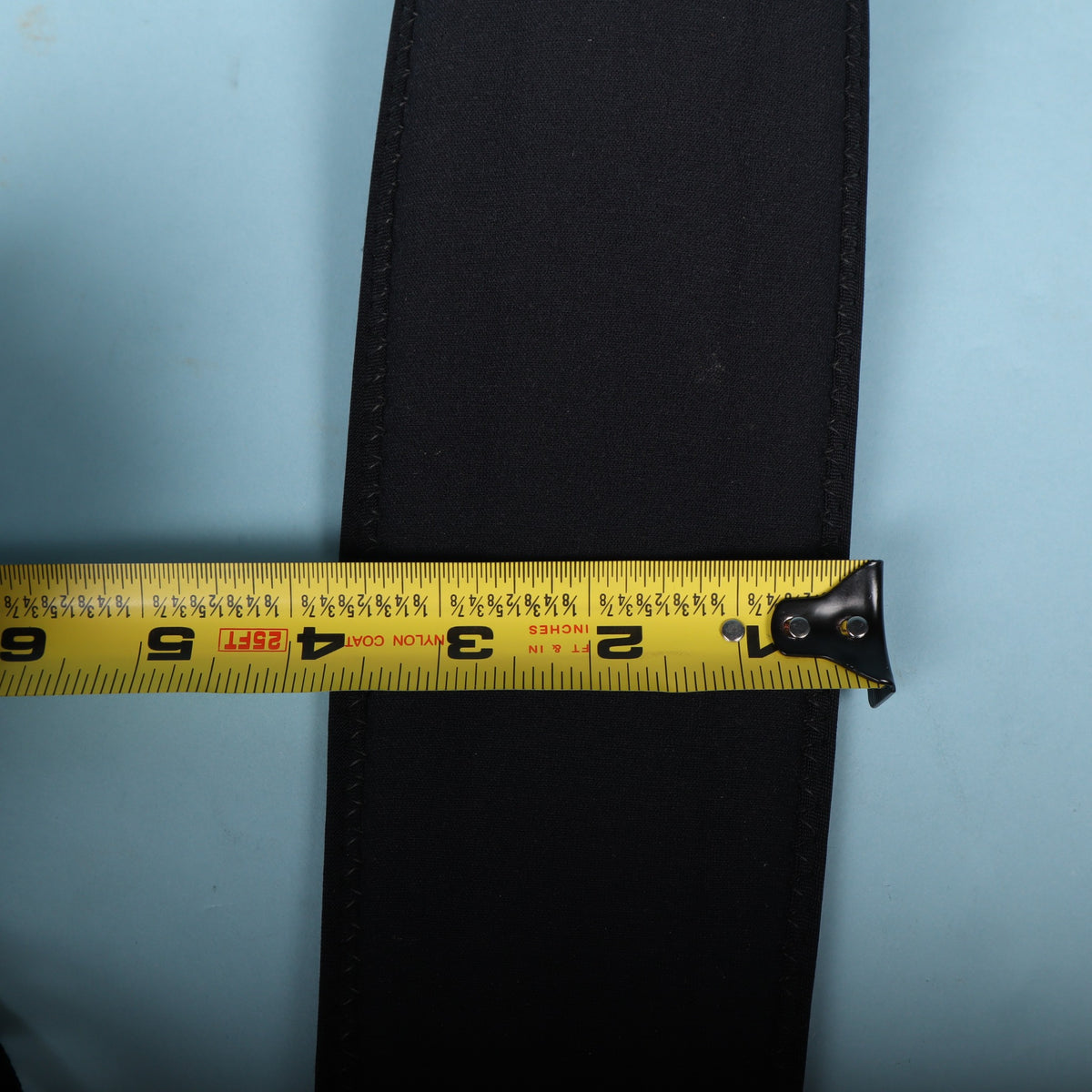 Tape measure showing the neoprene pad width at approximately 3 inches.