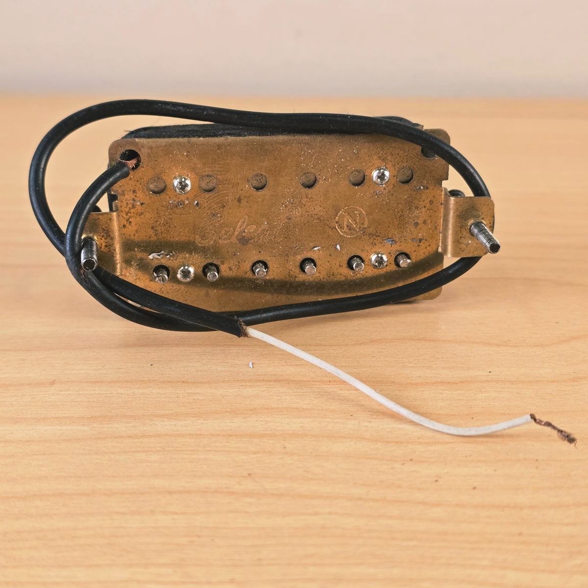 Angle view of the brass baseplate and wiring leads of the Jackson pickup