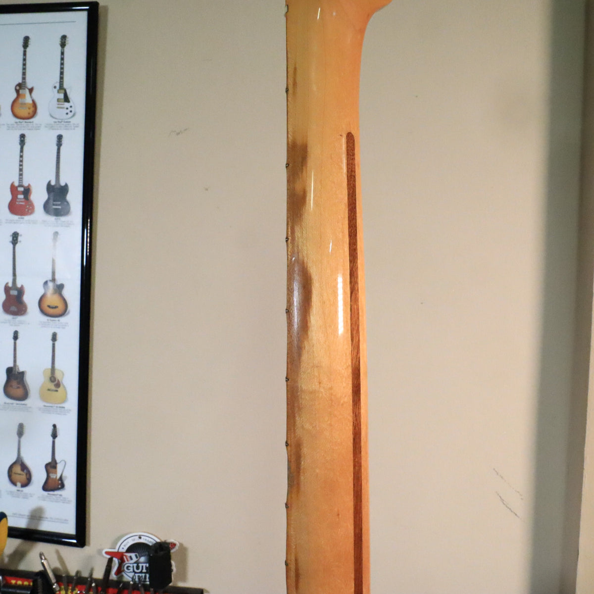 Rear of maple neck showing skunk stripe and finish wear along the edge