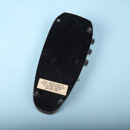 Bottom view displaying the black metal baseplate, rubber feet, and battery care sticker