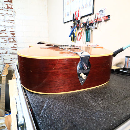 Bottom edge of the guitar body showing the chrome trapeze tailpiece mount.