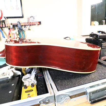 Side profile of the mahogany rim on a padded workbench.