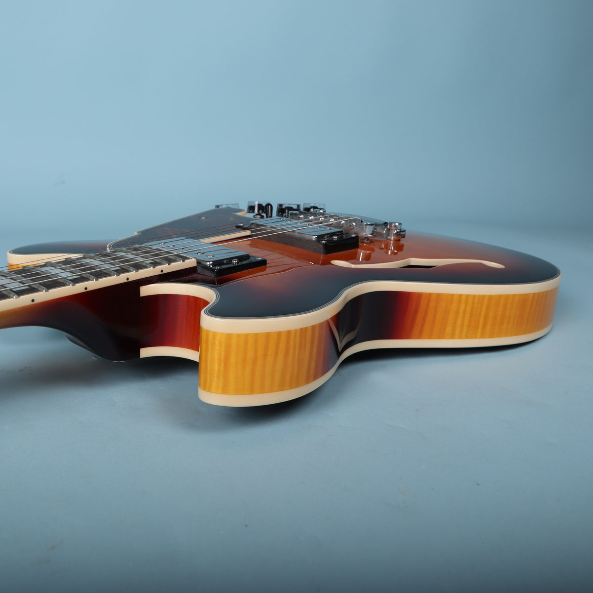Bass-side upper cutaway and rim binding detail on the Premier Mini DC body.