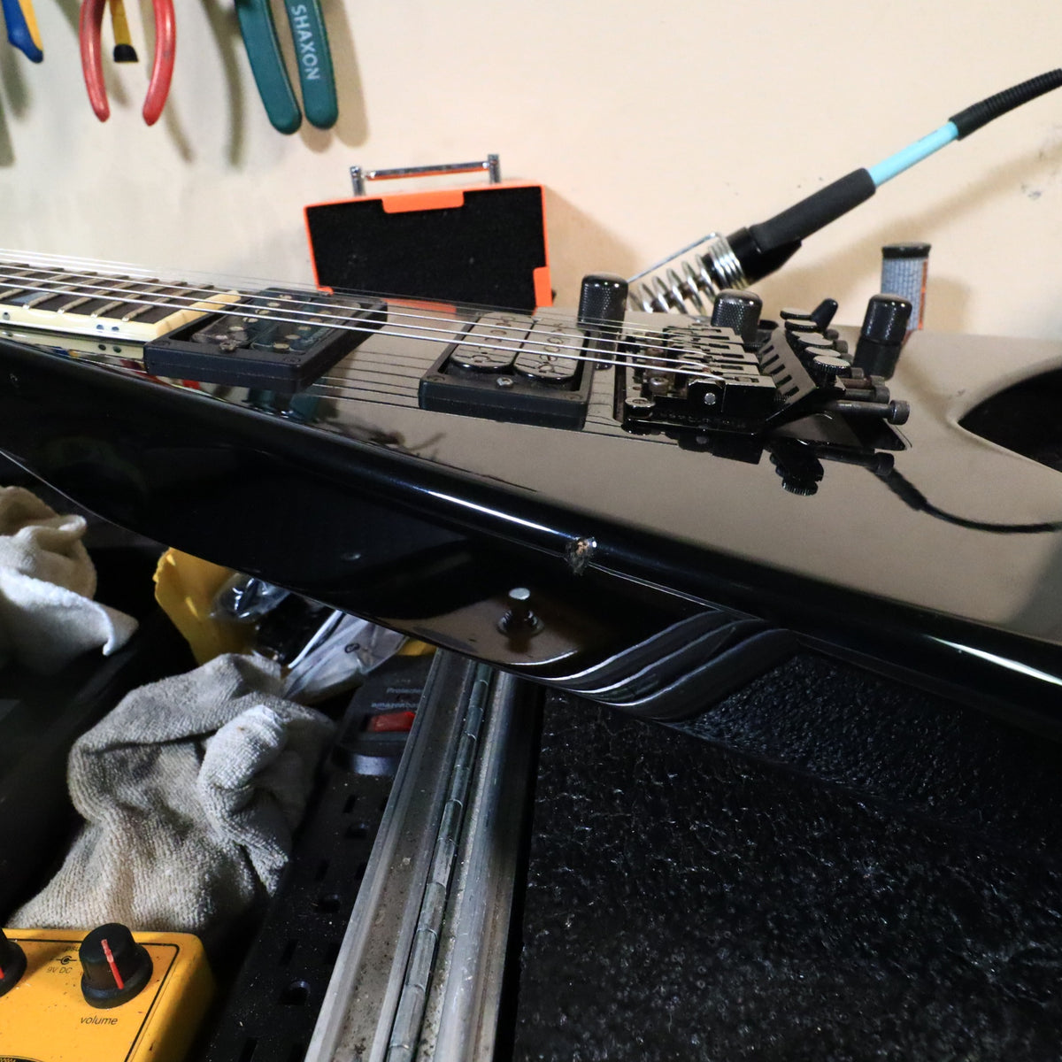 Angled view of the Jackson King V body showing the Floyd Rose bridge, pickups, and edge dings