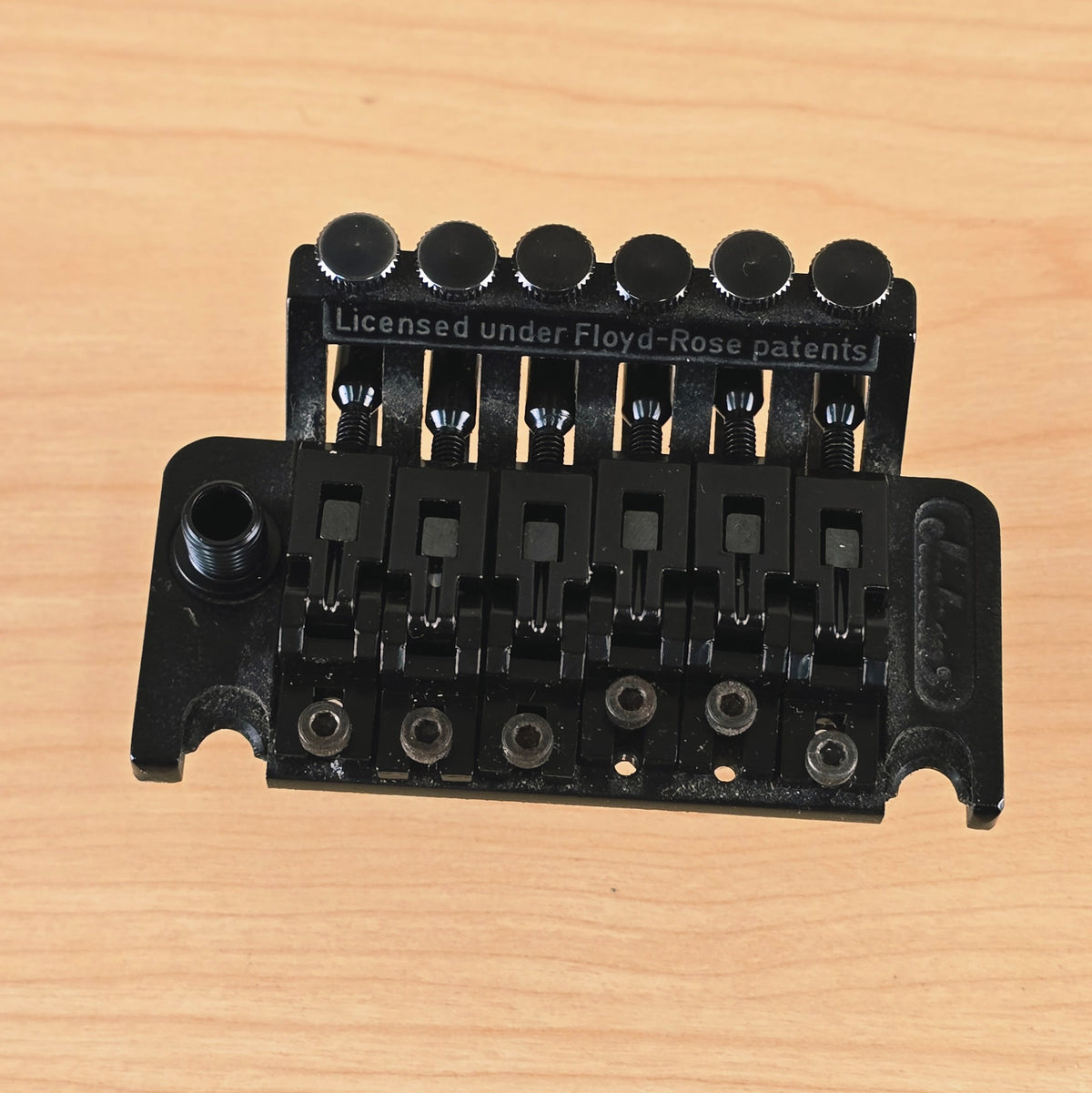 Top perspective showing the arm collar, saddles, and fine-tuner ridge.