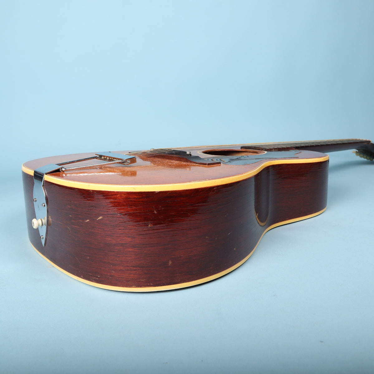 Bass-side profile of the mahogany body of a Gibson B-25-12.