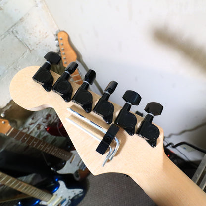 Back of maple neck resting on tech bench neck support.