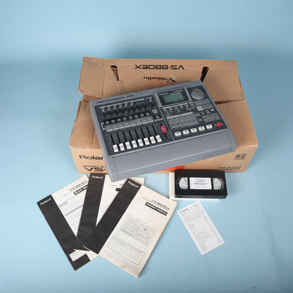 Full setup overview of Roland VS-880EX workstation, box, and included printed user manuals.