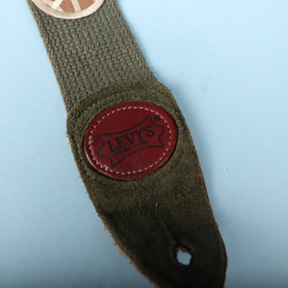 Detailed view of the embossed Levy's leather badge and suede end tab with button hole
