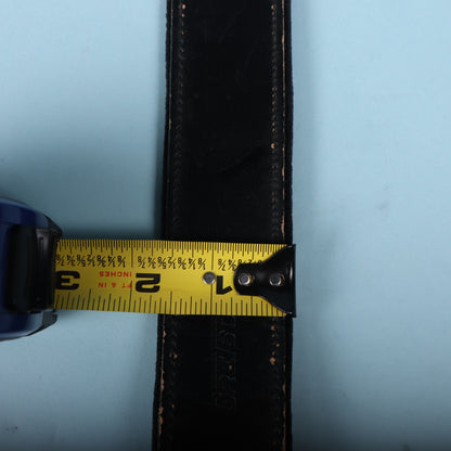 Tape measure displaying 2-inch width of Gretsch black leather strap.