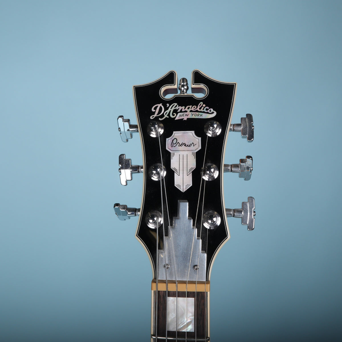 Front of the headstock with D'Angelico logo, Premier badge, and Art Deco truss cover.