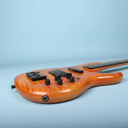Treble-side rim profile showing the output jack and control knob layout.