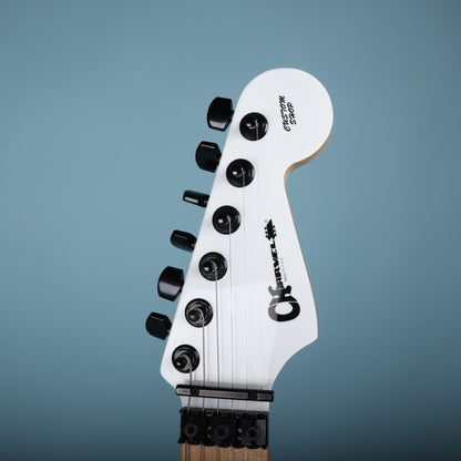 Front headstock view showing white finish, black Charvel Custom Shop logo, and locking nut.