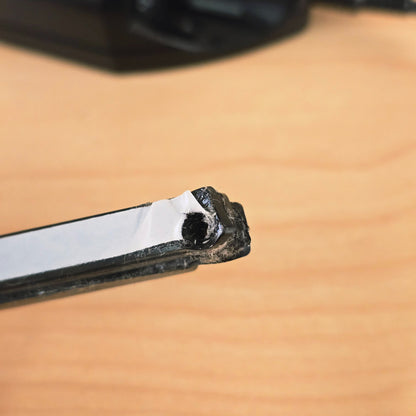 Detail of mounting hole and tape backing on end of Roland GK-2A pickup bar.
