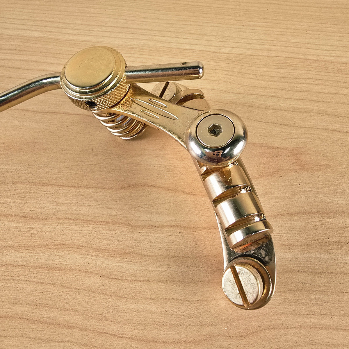 Top-down detail of Duesenberg Les Trem II bridge string-anchor bar and mounting screw slot