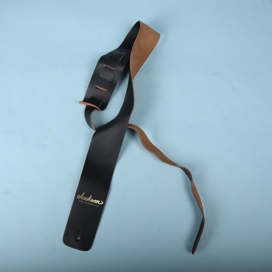 Full view of Jackson The Bloodline black leather guitar strap showing ladder adjustment tail