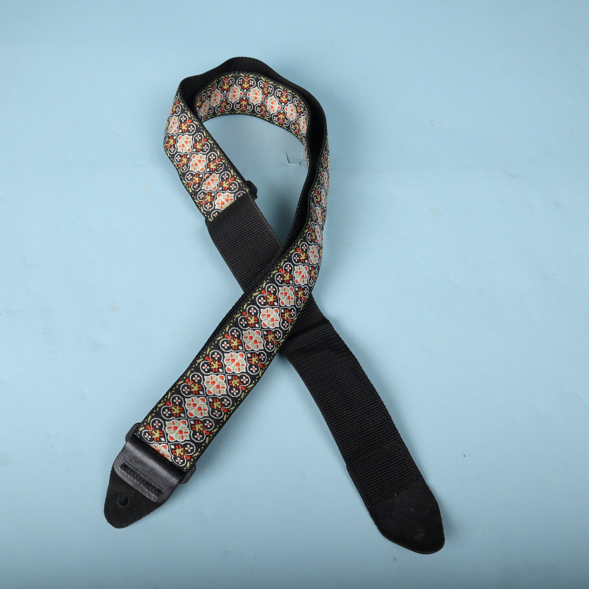 Ernie Ball jacquard guitar strap laid out showing front weave and black backing