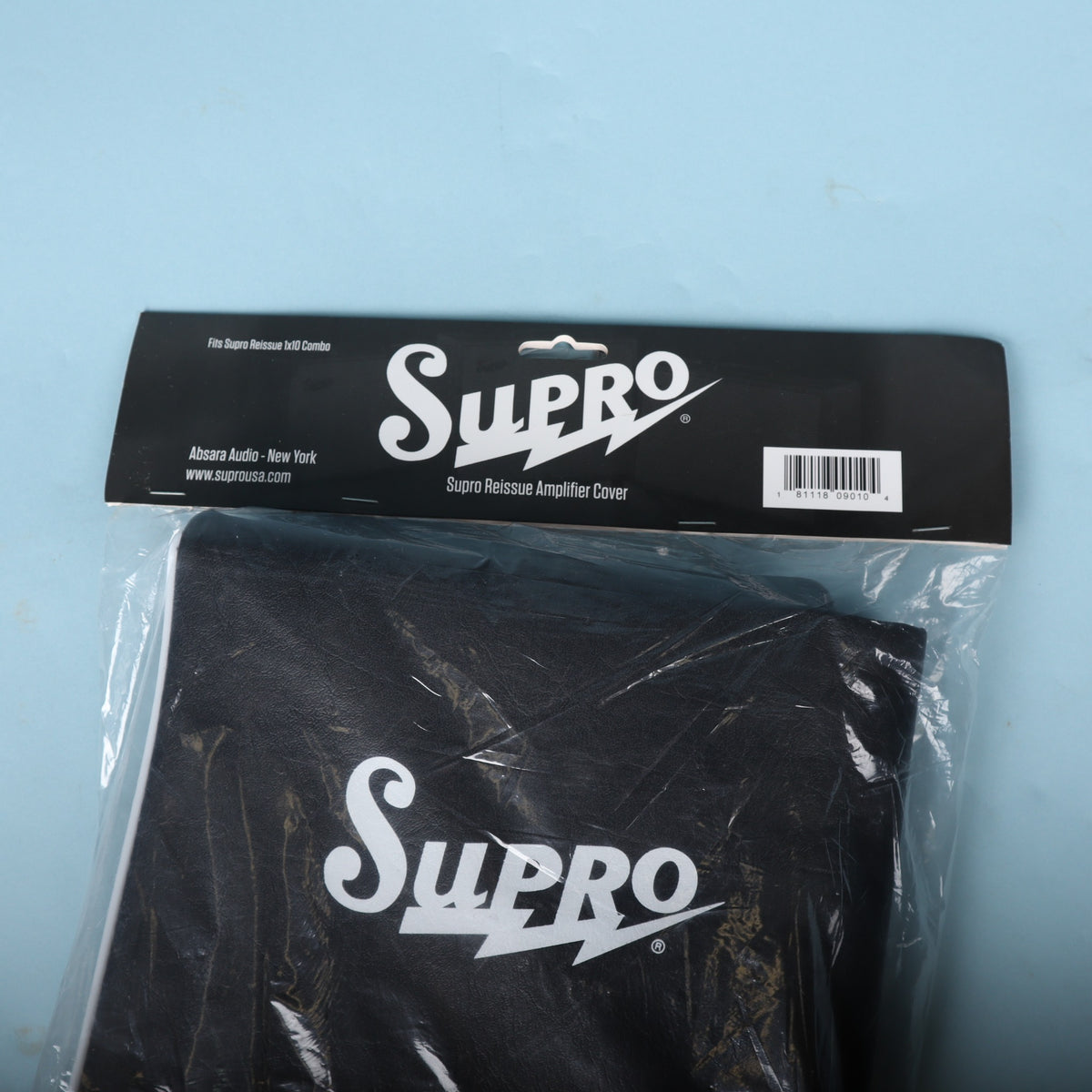 Angle view of Supro Reissue amplifier cover in original header bag.